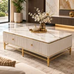 Designer white marble centre table with two gold-knob drawer fronts, fluted panels and gold metal frame in an elegant living room.