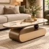 Modern oval marble centre table with gold-trimmed tabletop and curved bronze base beside a beige sofa.