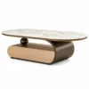 Elvoro luxury oval marble centre table with white veined top, curved bronze stainless steel base and spherical support on white background.