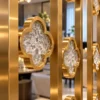 Close-up of textured premix glas quatrefoil motif in gold stainless steel partition