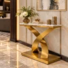 Luxury marble console table with curved gold pedestal in elegant entryway