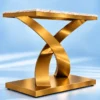Angled view of white marble console table with intersecting gold metal base
