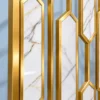 Close view of Hexara Gold PVD stainless steel frame and marble-look decorative inserts