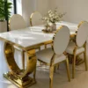 Gold stainless steel marble dining table with white upholstered chairs