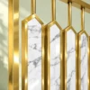 Close-up of gold PVD stainless steel frame and white marble-design partition inserts
