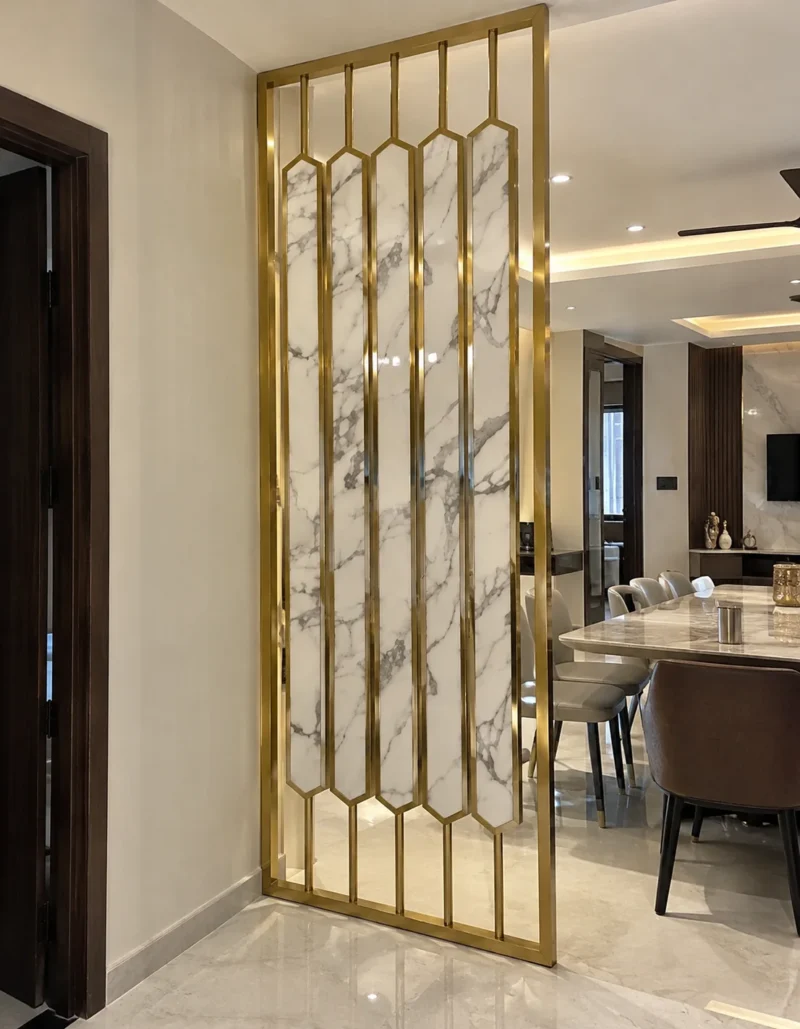 Vertical marble-design gold stainless steel room divider near dining room entrance