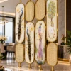 Gold peacock room divider with artistic oval panels between living and dining areas