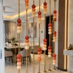 Floor to ceiling stainless steel partition with marble beads