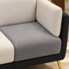 Close view of Monvera cream and grey sofa fabric and padded armrest