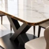 Close up of marble dining table top and black stainless steel X base