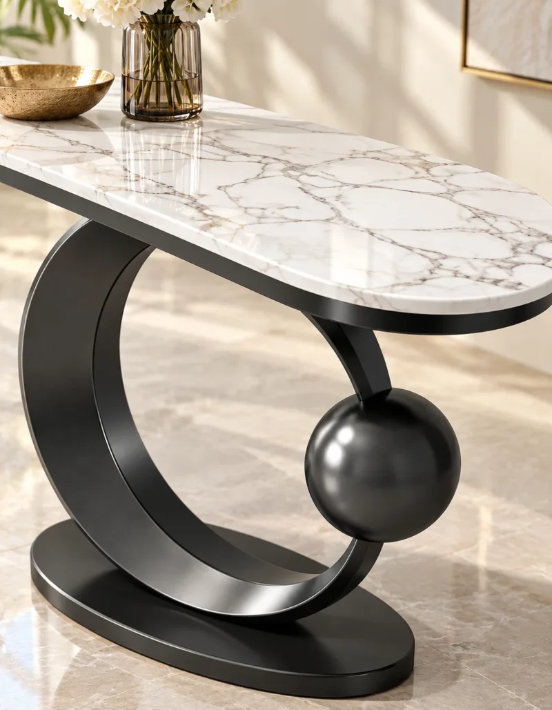 Close-up of polished white marble console tabletop with grey veining and black stainless steel sculptural frame.