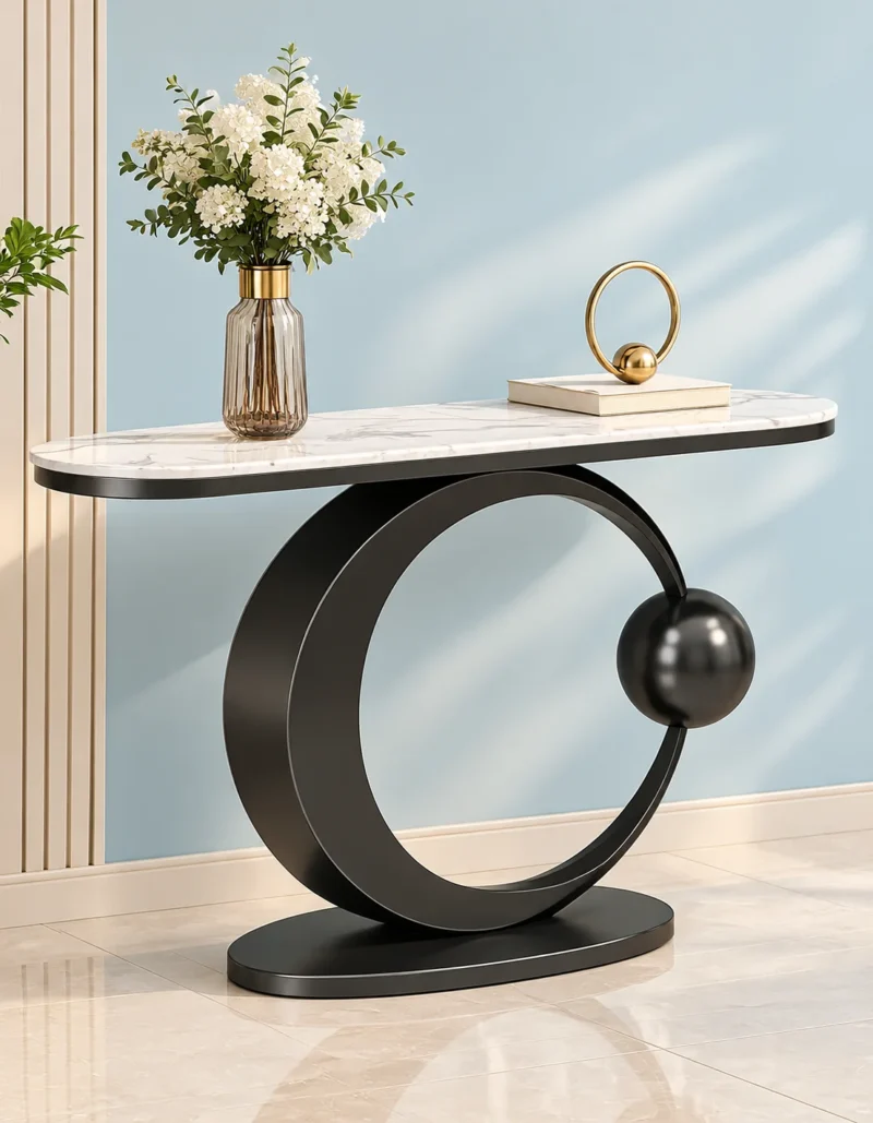 Orbis luxury console table with oval white marble top, black ring pedestal and decorative flower vase.