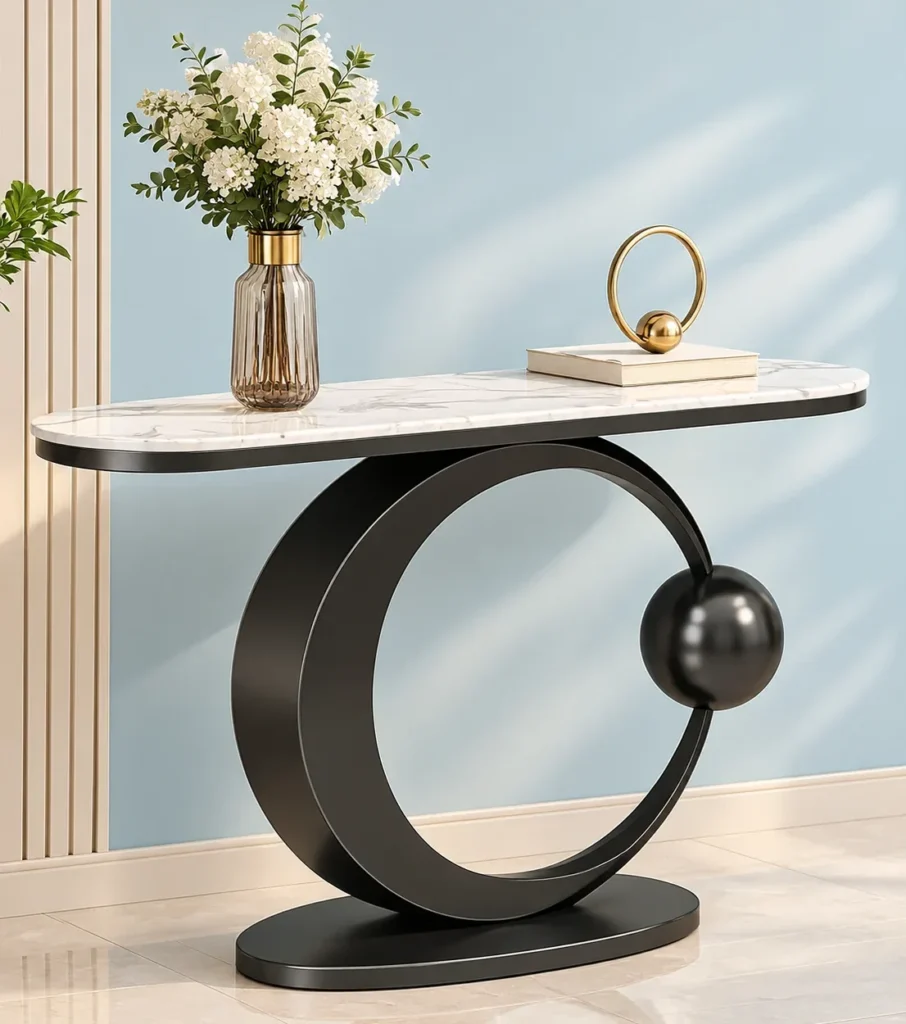 Orbis luxury console table with oval white marble top, black ring pedestal and decorative flower vase.