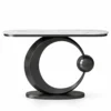 Orbis black marble console table with white marble top, circular stainless steel base and black sphere on white background.