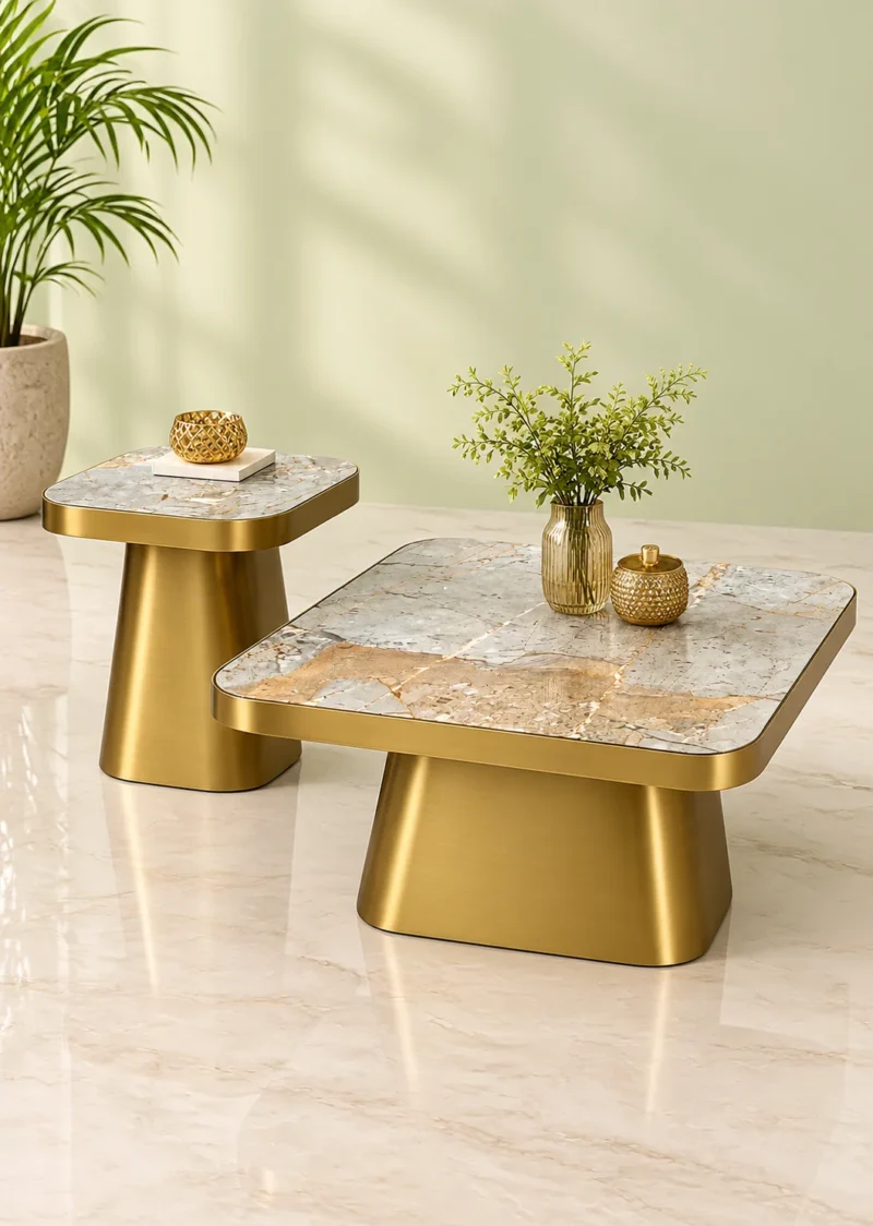 Luxury marble centre table and matching small accent table with gold bases styled with plants and decorative accessories.