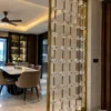 Stainless steel crystal bead room divider beside a contemporary dining room