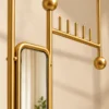 Close view of Solvane gold stainless steel mirror frame and hanging hooks
