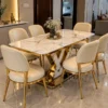 Luxury marble dining table with V shaped gold base and six chairs