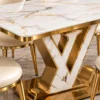 Close up of marble dining table top and V shaped stainless steel pedestal