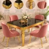 Valora black marble dining table with gold legs and pink chairs
