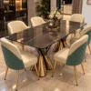 Black marble dining table with gold dual pedestal base and upholstered chairs
