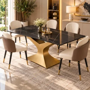 Rectangular black marble dining table with gold stainless steel base and cream upholstered chairs in a luxury dining room.