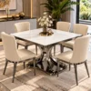 Luxury square marble dining table with dark metallic curved pedestal and six cream fabric dining chairs in a contemporary interior.