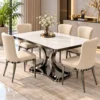 Modern square marble dining table set for six with cream upholstered chairs, stainless steel frames and curved pedestal base.