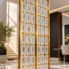 Chain link Premix Glas room divider with gold frame near modern staircase
