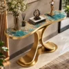 Elevated angled view of teal blue marble console table with gold veining, rounded ends and sculptural stainless steel pedestal.