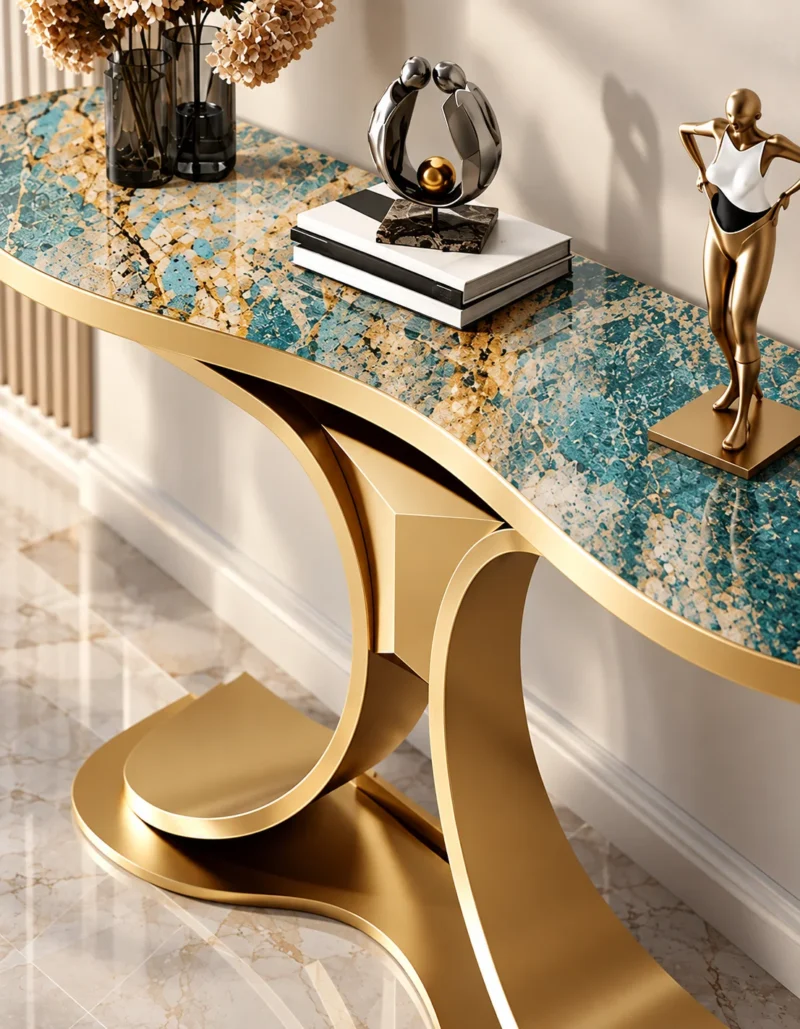 Close-up of teal marble console tabletop with cream and gold veining above a curved gold stainless steel dual-wing base.