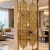 Gold floral stainless steel partition separating luxury living and dining areas