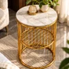 Luxury white marble side table with polished gold cylindrical frame beside a cream accent chair