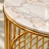 Close-up of white marble side table top with gold grey veining and polished gold stainless steel lattice frame