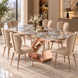 Six seater designer marble dining table with rose gold sculptural base and beige upholstered dining chairs