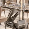 Close-up of gunmetal sculptural stainless steel dining table base with oval cut-out beneath patterned marble top