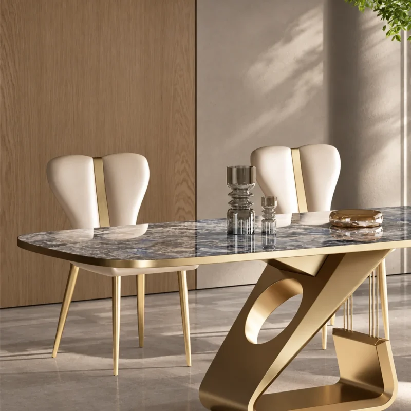 Close-up of gunmetal sculptural stainless steel dining table base with oval cut-out beneath patterned marble top