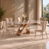Luxury six seater marble dining table with gold sculptural stainless steel base and cream upholstered chairs