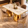 Designer marble dining table with faceted gold pedestal base
