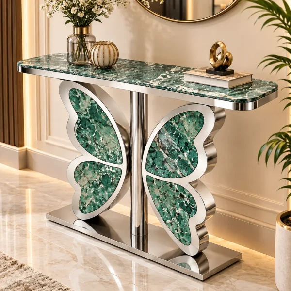 Luxury entryway console table with green marble top and silver butterfly-inspired stainless steel base beneath a round wall mirror.