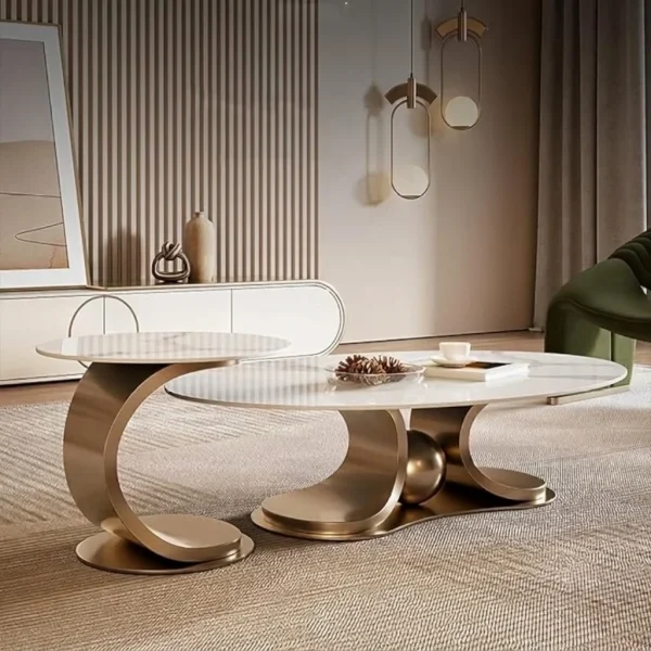 Side view of oval marble nesting table set with champagne gold metal frame on textured beige carpet